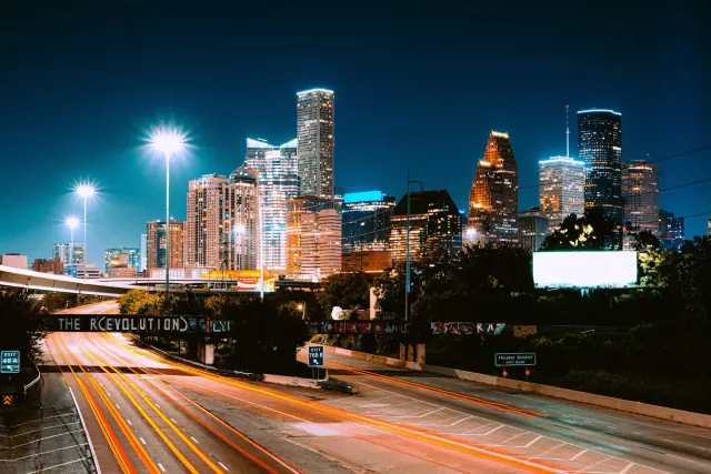 A road leading toward a city skyline