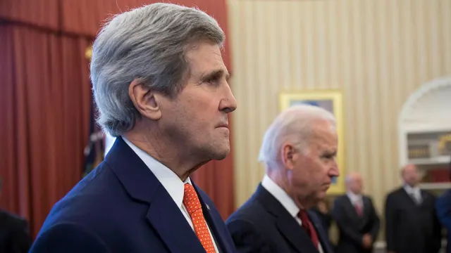 John Kerry in the foreground with Joe Biden behind him
