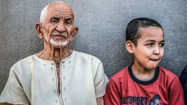 An older adult and a child sitting together