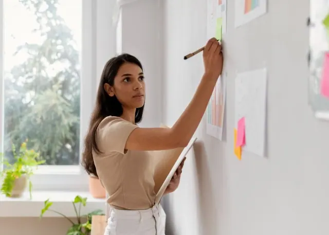 A woman writing on a board