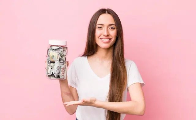 A woman holding a jar of banknotes
