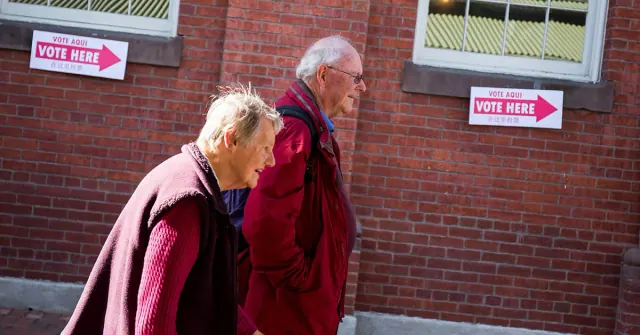 Archival photograph outside a polling place with a Vote Here sign