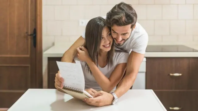 Two people using a laptop together