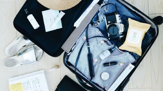 A suitcase containing travel items
