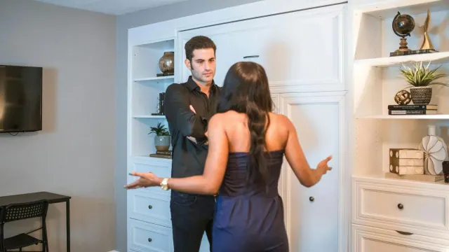 A staged image of a couple talking indoors