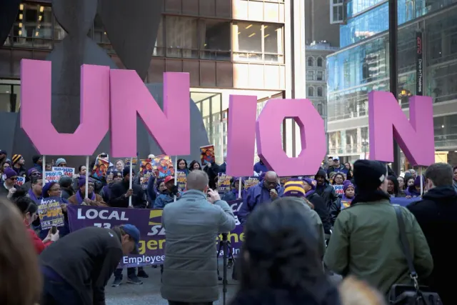 A crowd gathered near large pink Union letters