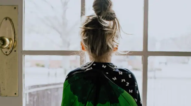 A child looking through a window