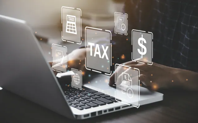 Laptop displaying tax symbols