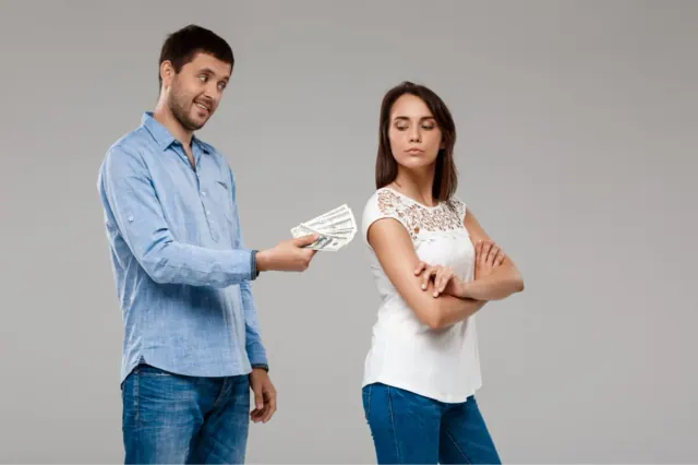 A man is pictured offering a woman several hundreds of dollars