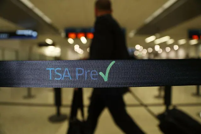 Travelers go through the TSA PreCheck security point at Miami International Airport