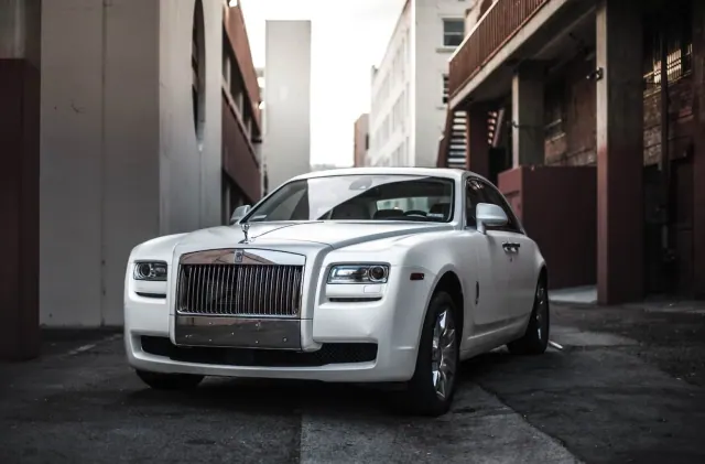 White Rolls Royce parked on a city street