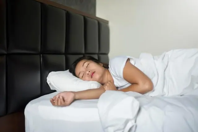 A person sleeping in a bed