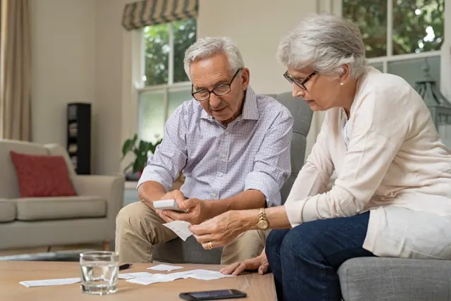 An older couple reviewing paperwork together