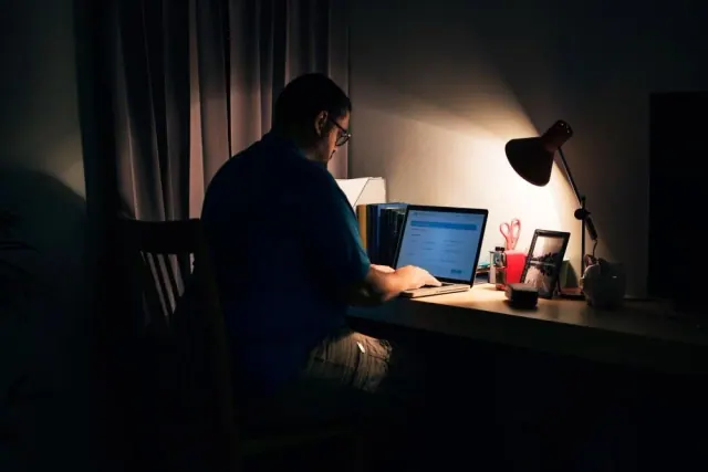A person working at a desk at night