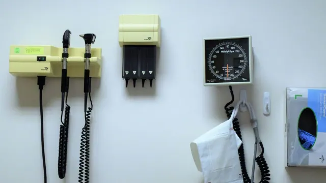 Medical instruments hanging on a white wall in a hospital.