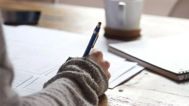 A person writing in a notebook