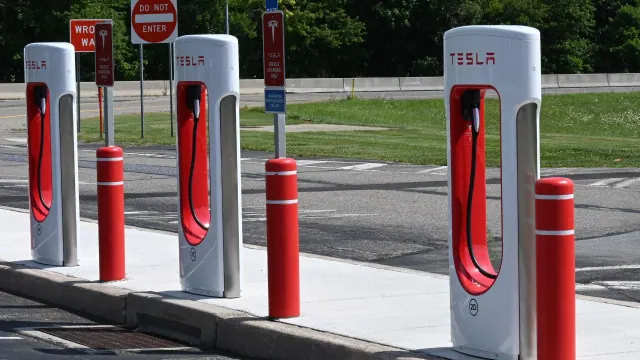 Tesla-branded charging units beside parking spaces