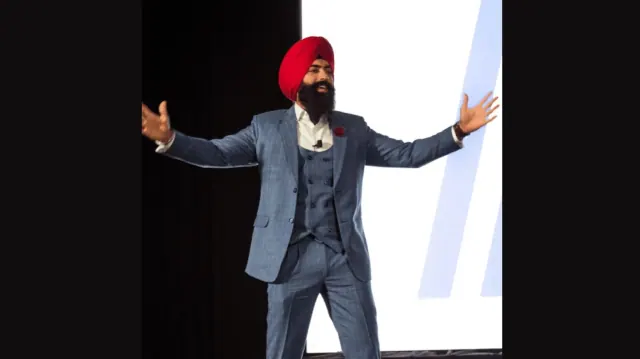Jaspreet Singh on Stage Giving a Speech