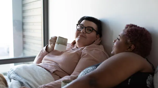 Two people sitting together on a sofa