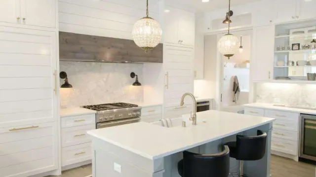 A white kitchen with a central island