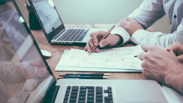 People reviewing paperwork at a desk