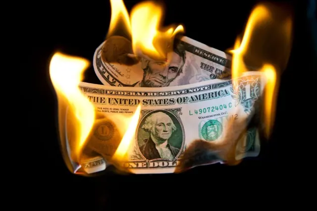 Illustrative burning-banknote photograph