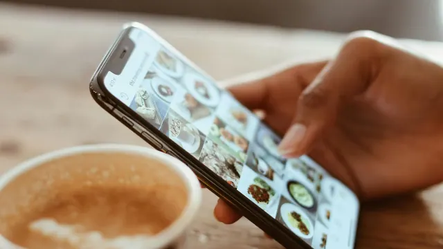 Woman on her social media with a cup of coffee