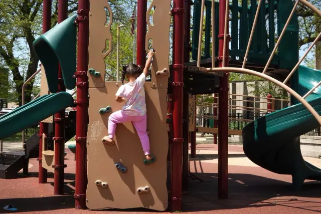A child climbing on playground equipment
