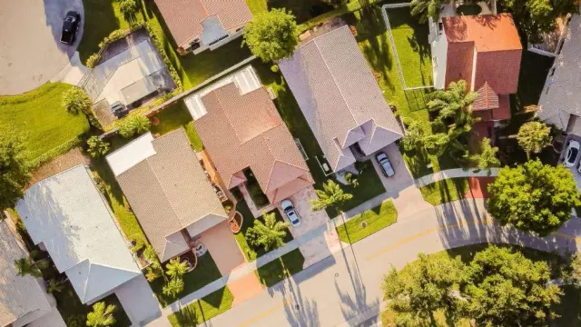 Aerial view of houses and parked vehicles