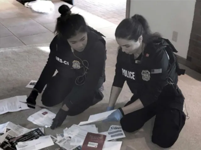 Image of two IRS agents performing an investigation