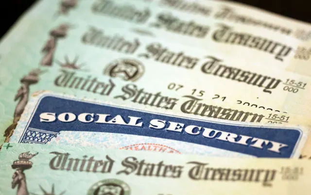 A Social Security card resting on U.S. currency