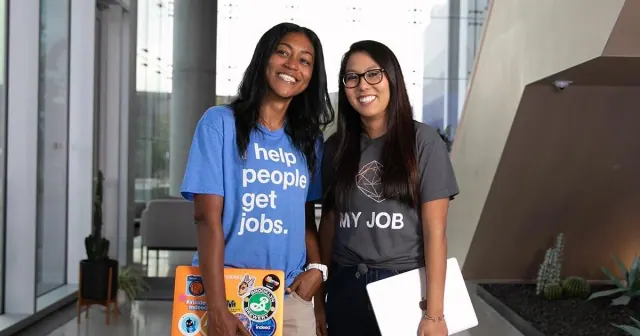 Two people standing together in an office