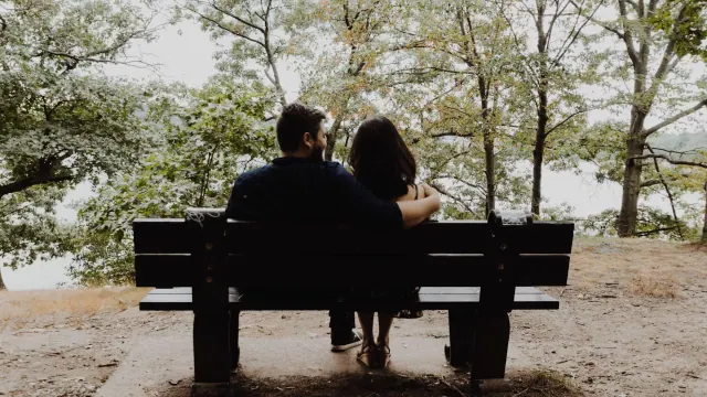 Two people sitting together on a bench