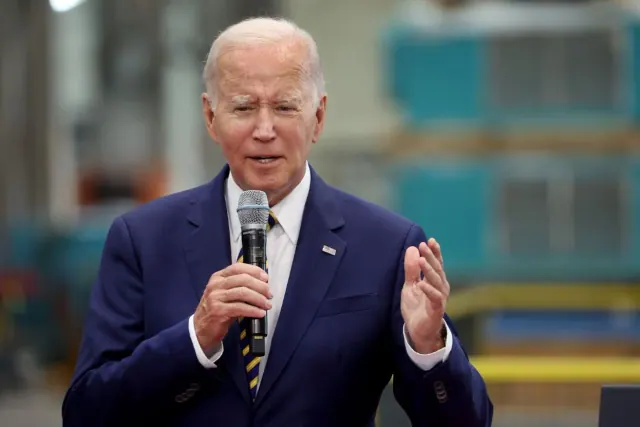 Archival photograph of Joe Biden holding a microphone