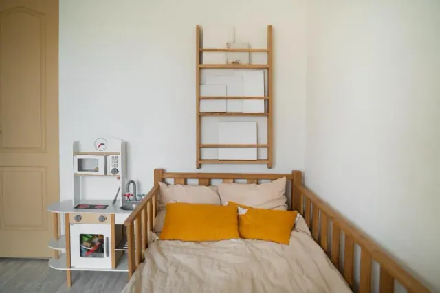 A small bedroom with a ladder