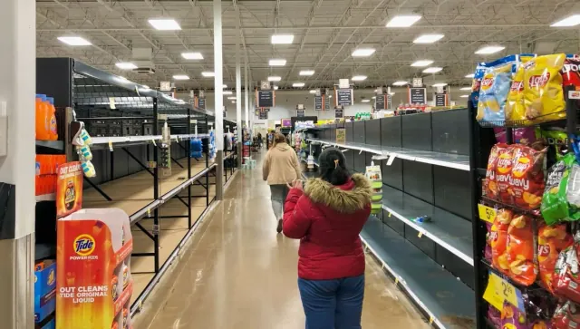 A shopper in a grocery aisle