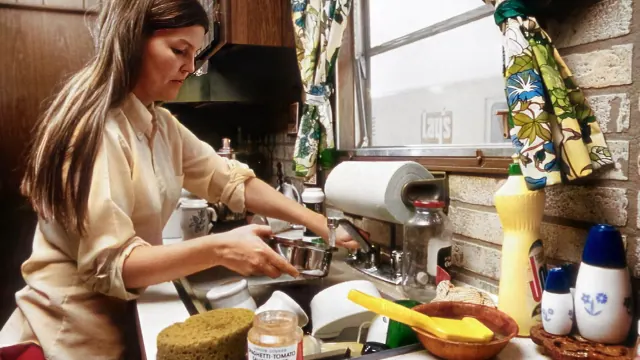 An adult preparing food in a kitchen