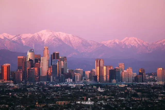 A city skyline beneath mountains