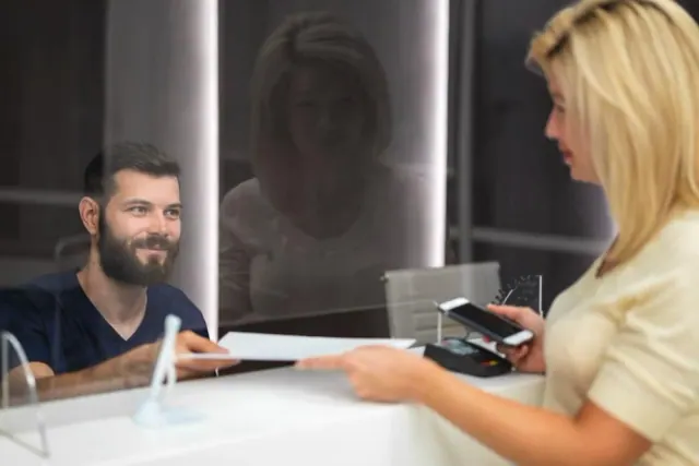 A customer using a payment card at a counter