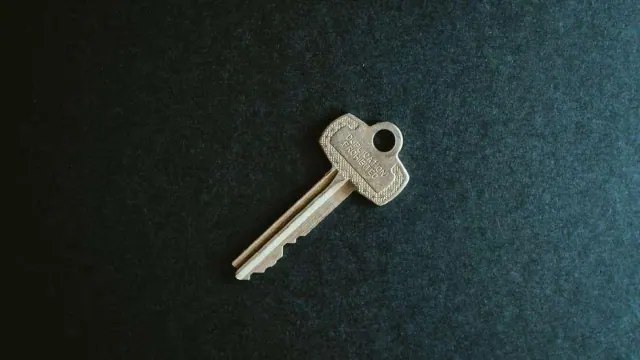 A key lying on a dark surface