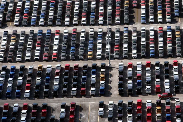 Rows of vehicles parked in a large lot