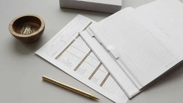 Household paperwork and a pencil on a desk