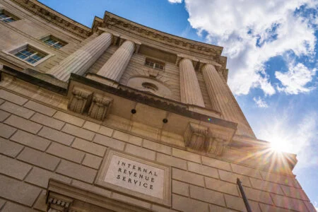WASHINGTON, DC - SEPTEMBER 15: The sun flairs over the side of the U.S. Internal Revenue Service (IRS) headquarters building on September 15, 2024, in Washington, DC. the IRS crackdown has recovered more than 1.3 billion
