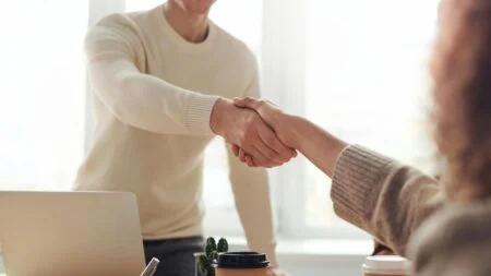 Two men shaking hands in a job interview