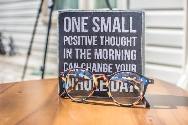 A decorative sign with glasses in front