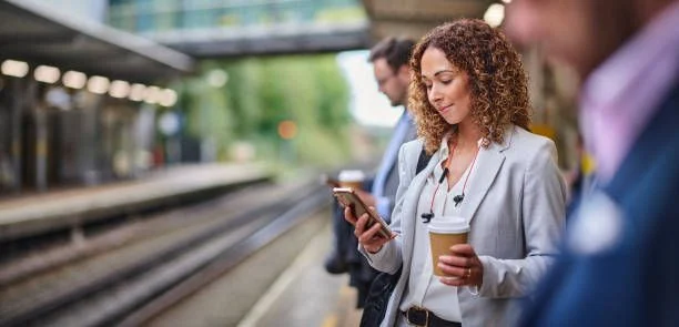 A person using a phone on a train platform