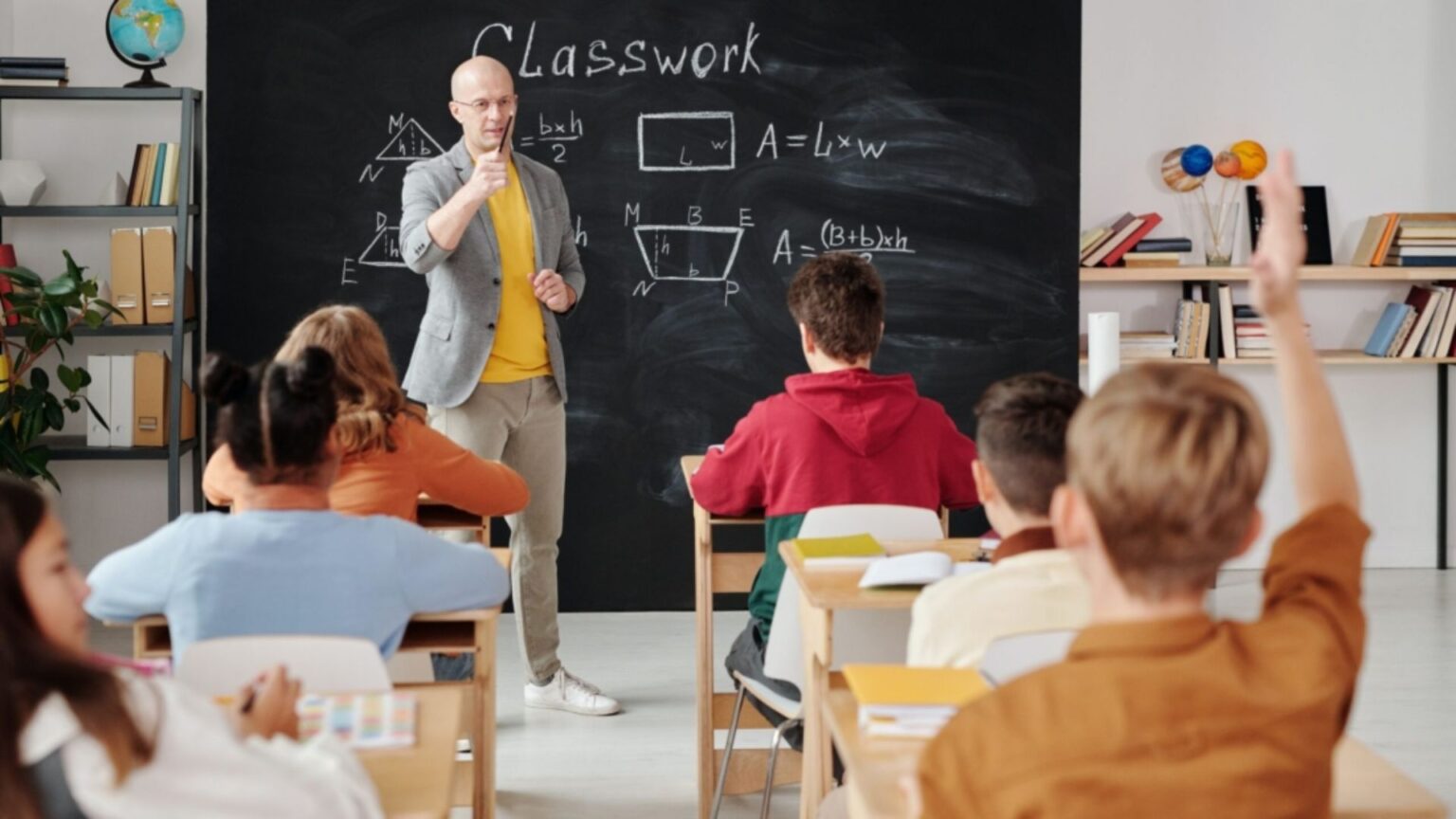 Techer educating classroom of students